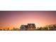 Charming two-story home bathed in the warm glow of a sunset against a stunning twilight sky at 774 Forrester Cemetery Rd, Covington, GA 30014