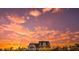 Exterior view of farmhouse with sunset sky at 774 Forrester Cemetery Rd, Covington, GA 30014