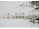 A charming two-story farmhouse with dormer windows is framed by a snowy landscape at 774 Forrester Cemetery Rd, Covington, GA 30014