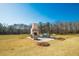 Outdoor fireplace featuring ample seating, set in a sprawling backyard landscape at 774 Forrester Cemetery Rd, Covington, GA 30014