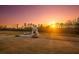 Outdoor fireplace featuring ample seating, set in a sprawling backyard landscape at sunset at 774 Forrester Cemetery Rd, Covington, GA 30014