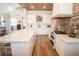 Bright kitchen features a large marble island, stainless appliances, and a brick backsplash at 774 Forrester Cemetery Rd, Covington, GA 30014