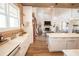 Open-concept kitchen with marble countertops, a farmhouse sink, and wood-look floors at 774 Forrester Cemetery Rd, Covington, GA 30014