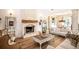 Bright living room with a brick fireplace, hardwood floors, and comfortable seating arrangement at 774 Forrester Cemetery Rd, Covington, GA 30014