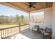 A covered porch with wood-paneled ceilings and outdoor furniture for relaxing with views of the wooded landscape at 774 Forrester Cemetery Rd, Covington, GA 30014