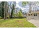 Expansive backyard featuring a deck, mature trees, and lush lawn, perfect for outdoor enjoyment at 1624 Linda Dr, Decatur, GA 30032