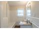 Bright bathroom featuring a granite countertop, a shower/tub combo, and a mirrored cabinet at 1624 Linda Dr, Decatur, GA 30032