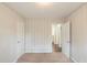 Bright bedroom featuring a closet, an open door to a bath, and neutral carpet at 1624 Linda Dr, Decatur, GA 30032
