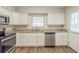 Modern kitchen featuring stainless steel appliances, granite countertops, and white cabinets at 1624 Linda Dr, Decatur, GA 30032