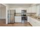 Updated kitchen with stainless steel appliances, light countertops and white cabinets at 1624 Linda Dr, Decatur, GA 30032