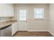 Bright kitchen featuring granite countertops, stainless steel dishwasher, and wood-look flooring at 1624 Linda Dr, Decatur, GA 30032