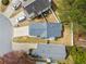 A premium aerial view of the roof, backyard, driveway and neighborhood at 2365 Parkside Club Ln, Lawrenceville, GA 30044