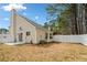 House with a sliding glass door leading to a cozy, fenced-in backyard at 2365 Parkside Club Ln, Lawrenceville, GA 30044