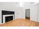 Living room showcasing hardwood floors, fireplace with white tile, and a doorway to another room at 2365 Parkside Club Ln, Lawrenceville, GA 30044
