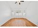 Bright living room featuring a large window, hardwood flooring, and neutral walls at 2365 Parkside Club Ln, Lawrenceville, GA 30044