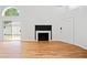 Sunlit living room with hardwood flooring, a fireplace, and a sliding door leading to the exterior at 2365 Parkside Club Ln, Lawrenceville, GA 30044