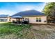 Exterior home view of a spacious backyard with a covered patio, hot tub, and ample space for outdoor activities at 25 Cherokee Hills Dr, Rydal, GA 30171