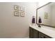 Bathroom with neutral walls, a vanity with gray cabinets, and decorative artwork at 25 Cherokee Hills Dr, Rydal, GA 30171