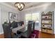 Bright dining room with a modern chandelier, dark wooden furniture and large window at 25 Cherokee Hills Dr, Rydal, GA 30171