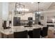 Modern kitchen features a granite island with counter seating, stylish light fixtures, and stainless steel appliances at 25 Cherokee Hills Dr, Rydal, GA 30171