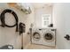 Functional laundry room with a front-load washer and dryer and storage shelves at 25 Cherokee Hills Dr, Rydal, GA 30171