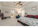 Spacious main bedroom featuring a tray ceiling, ceiling fan, and seating area at 25 Cherokee Hills Dr, Rydal, GA 30171