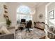 Bright office features a large arched window with a chandelier, hardwood floors, and neutral walls at 25 Cherokee Hills Dr, Rydal, GA 30171