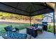 Outdoor patio area features a grill, seating and fire pit under a gazebo in a landscaped yard at 25 Cherokee Hills Dr, Rydal, GA 30171