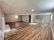 Spacious basement featuring wood floors, fireplace, bar, and built-in shelving at 3633 Mill Glen Dr, Douglasville, GA 30135
