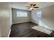 Bedroom featuring hardwood floors, two windows, and a ceiling fan at 3633 Mill Glen Dr, Douglasville, GA 30135
