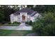 Aerial view of a single-story home featuring mature landscaping and a welcoming entrance; the front door is open at 433 Abbey Springs Way, Mcdonough, GA 30253