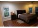 Bedroom featuring hardwood floors, a ceiling fan, and two large windows for natural light at 433 Abbey Springs Way, Mcdonough, GA 30253