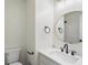 Bright bathroom with marble countertop, round mirror, black fixtures, and modern lighting at 445 Settlers Ridge Ln, Hiram, GA 30141