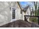 Back porch with brown wood planks, white siding, and view of backyard greenery at 445 Settlers Ridge Ln, Hiram, GA 30141