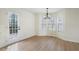 Bright dining area features a modern chandelier and a door leading to the outside deck at 445 Settlers Ridge Ln, Hiram, GA 30141