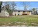 View of the backyard featuring a wooden deck, brick exterior, and lush green lawn at 2000 Fairburn Sw Rd, Atlanta, GA 30331
