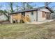 View of the backyard featuring a wooden deck, brick exterior, and lush green lawn at 2000 Fairburn Sw Rd, Atlanta, GA 30331