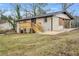 View of the backyard featuring a wooden deck, brick exterior, and lush green lawn at 2000 Fairburn Sw Rd, Atlanta, GA 30331
