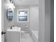 Bathroom featuring tiled floors, a new vanity, updated fixtures, and a large mirror and window at 2000 Fairburn Sw Rd, Atlanta, GA 30331