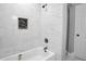 Bathroom with tiled walls, and updated shower fixtures featuring an inlaid storage shelf at 2000 Fairburn Sw Rd, Atlanta, GA 30331