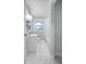 Bathroom featuring tiled floors, a new vanity, updated fixtures, and a large mirror and window at 2000 Fairburn Sw Rd, Atlanta, GA 30331