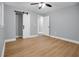 Bright bedroom with wood floors and a sliding barn door in a neutrally painted home at 2000 Fairburn Sw Rd, Atlanta, GA 30331