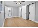 Bedroom with wood flooring that leads to the bathroom featuring modern sliding barn doors at 2000 Fairburn Sw Rd, Atlanta, GA 30331
