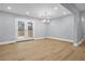 Dining area with hardwood floors, modern lighting, and access to the backyard patio through glass paneled doors at 2000 Fairburn Sw Rd, Atlanta, GA 30331