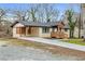 Lovely single-story home featuring a driveway, wood porch, and manicured landscaping at 2000 Fairburn Sw Rd, Atlanta, GA 30331