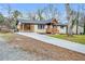 Attractive single-story home featuring fresh landscaping, a driveway, and wood porch at 2000 Fairburn Sw Rd, Atlanta, GA 30331