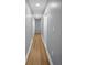 Hallway with hardwood floors and neutral paint offering access to various rooms throughout the home at 2000 Fairburn Sw Rd, Atlanta, GA 30331