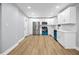 Bright kitchen features stainless steel appliances, white cabinets, and hardwood floors at 2000 Fairburn Sw Rd, Atlanta, GA 30331