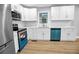 Bright kitchen features stainless steel appliances, white cabinets, and hardwood floors at 2000 Fairburn Sw Rd, Atlanta, GA 30331