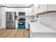 Bright kitchen features stainless steel appliances, white cabinets, and hardwood floors at 2000 Fairburn Sw Rd, Atlanta, GA 30331